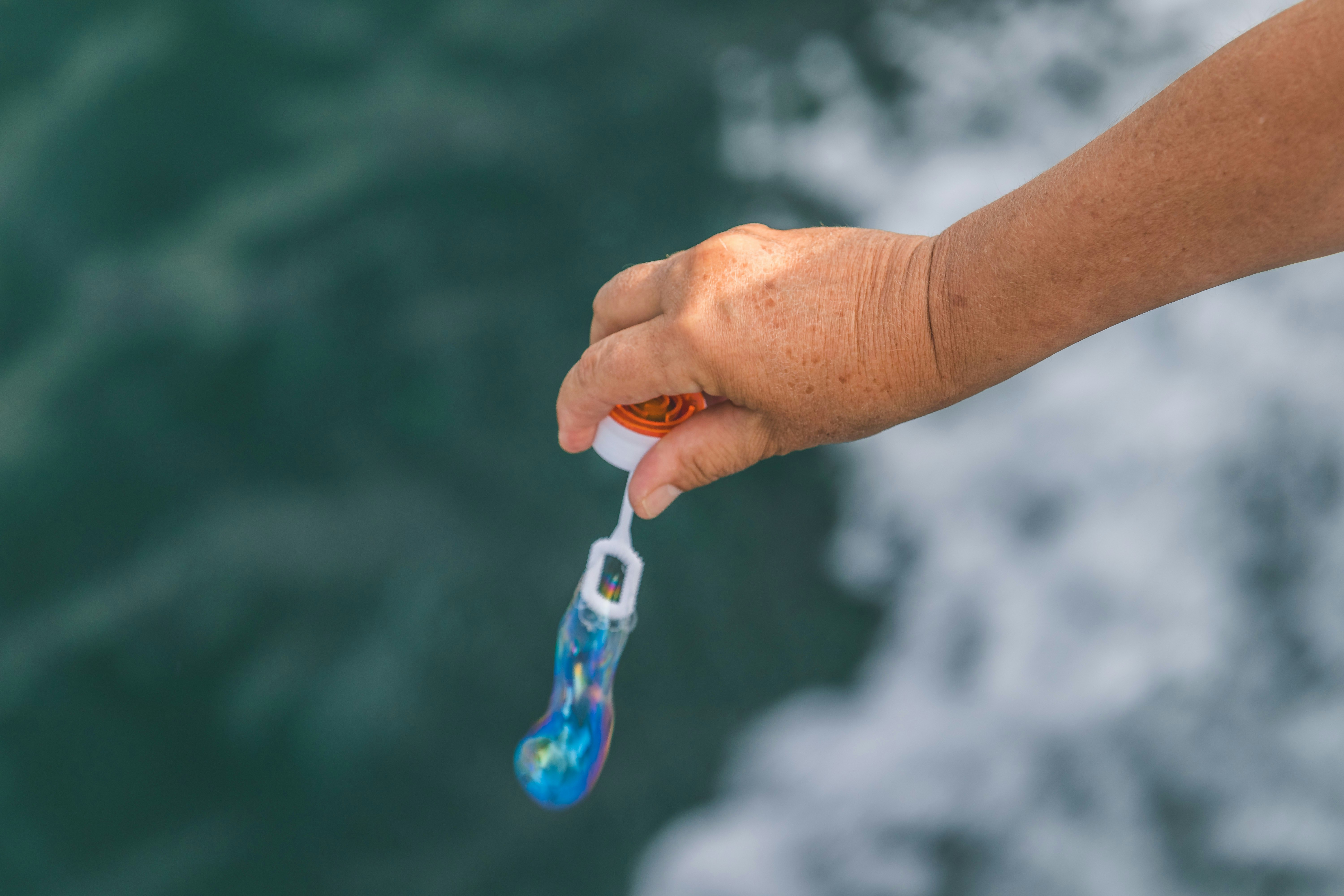 person holding blue and white toothbrush