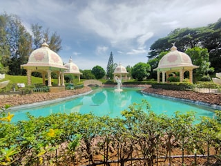 A serene garden with symmetrical water channels and Mughal-style pavilions.