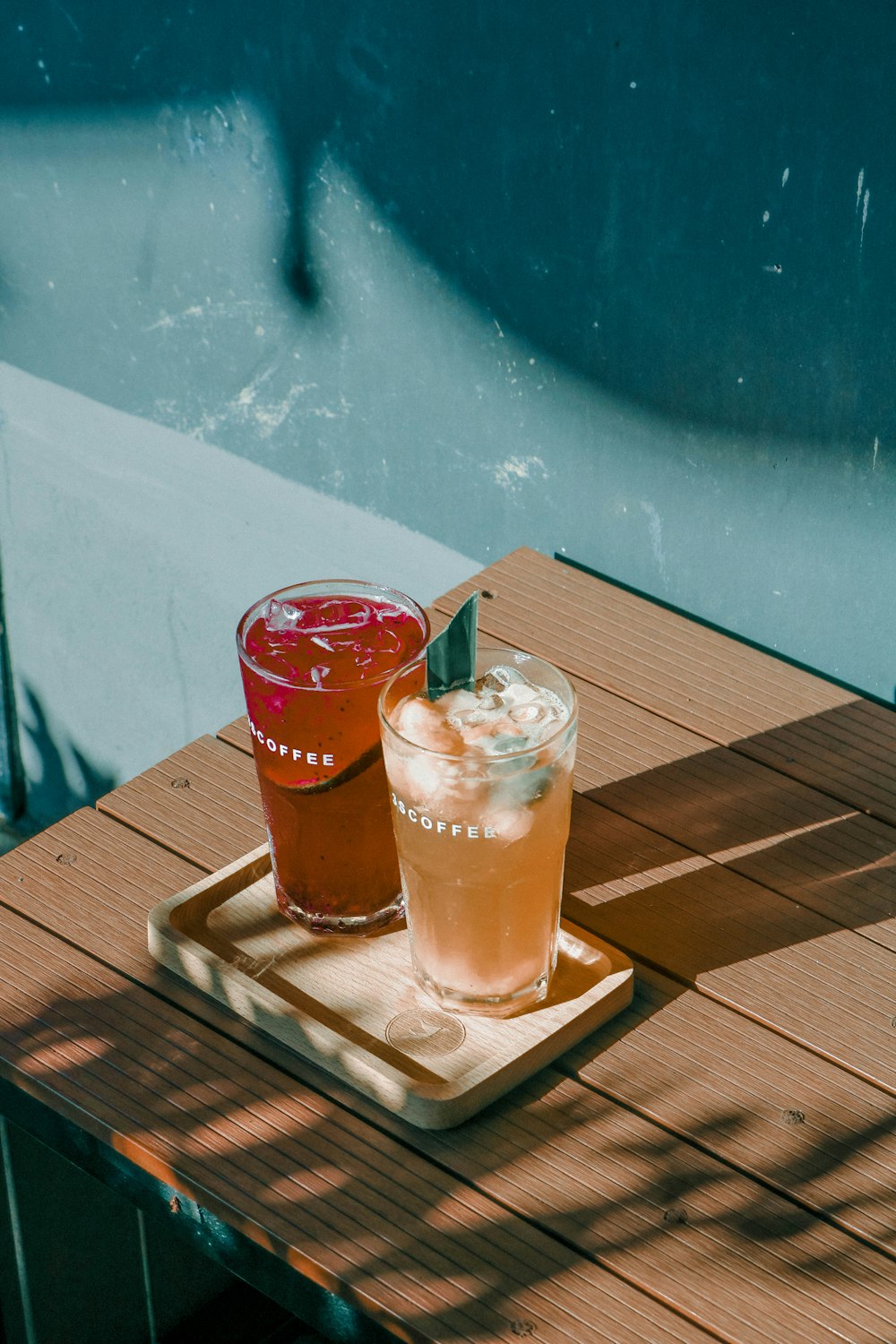 clear drinking glass with brown liquid on brown wooden table