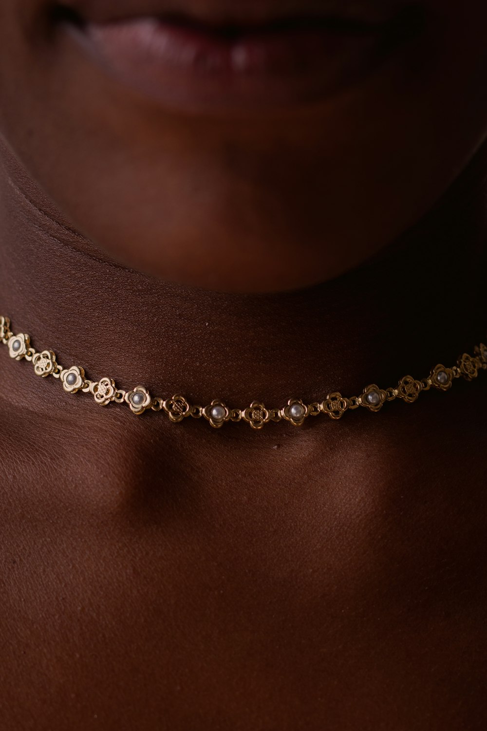 person wearing silver and gold necklace