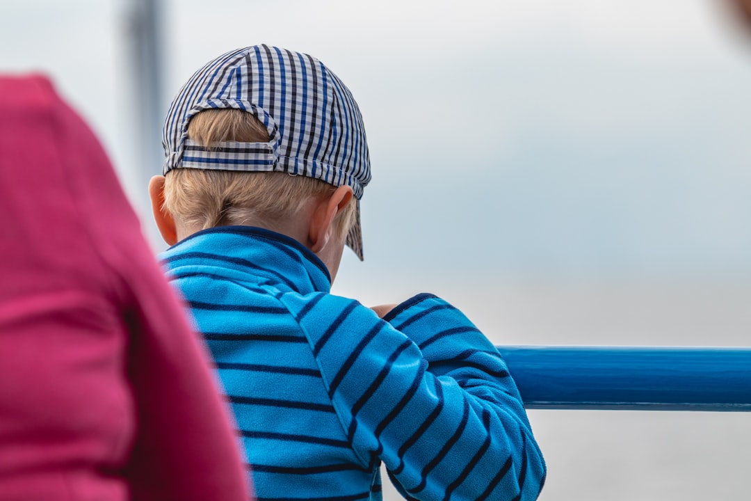 woman in blue jacket wearing gray knit cap