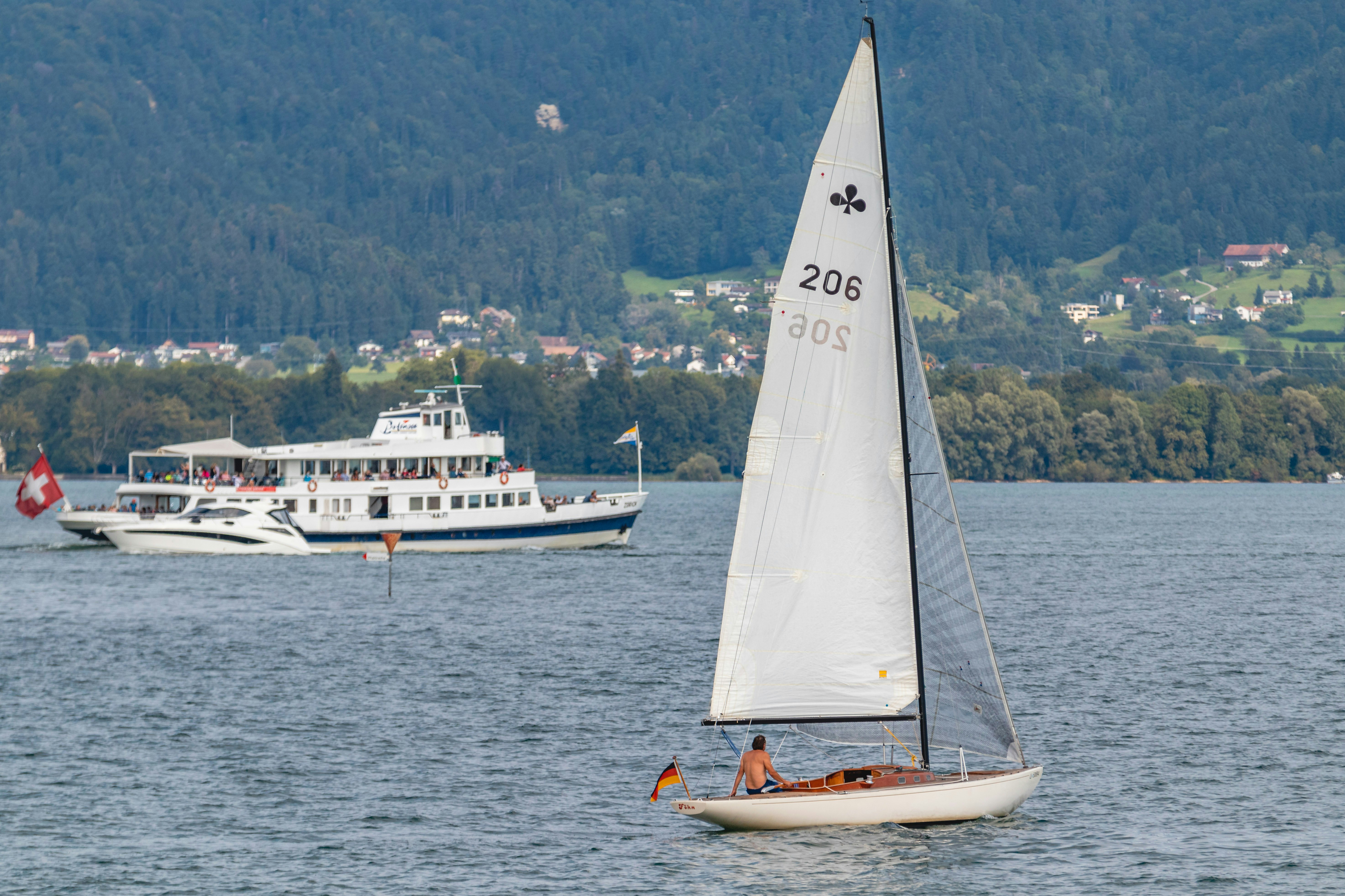 white sail boat on sea during daytime