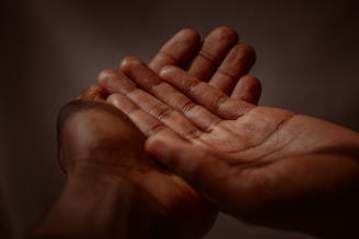 persons hand on black background