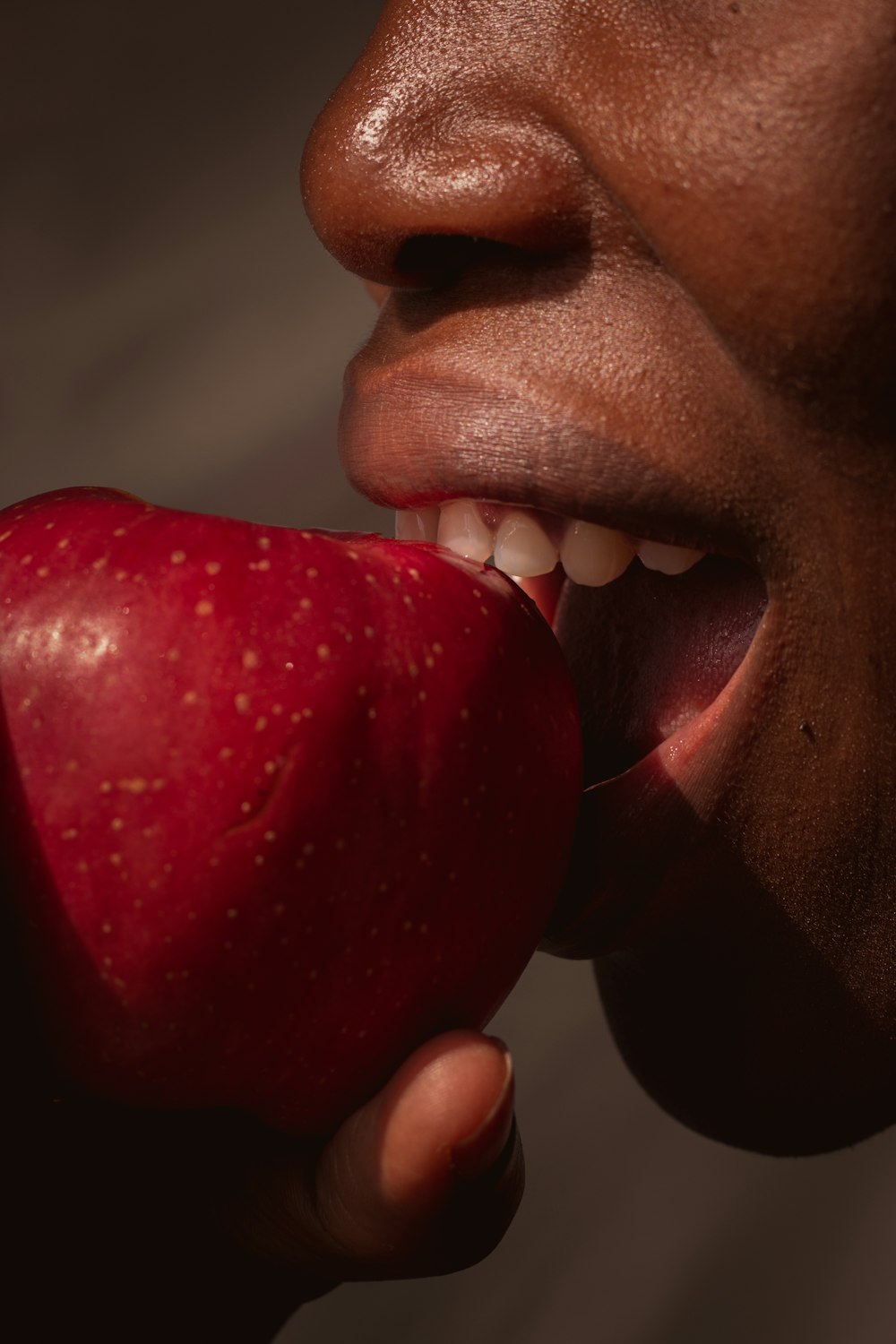 person holding red apple fruit