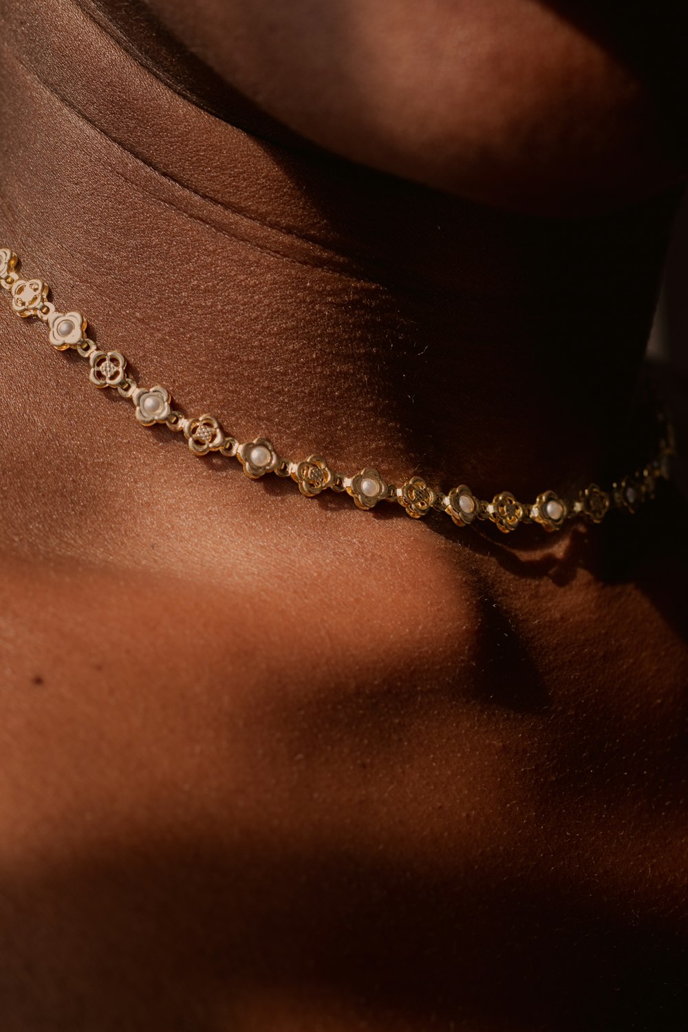 person wearing silver beaded necklace