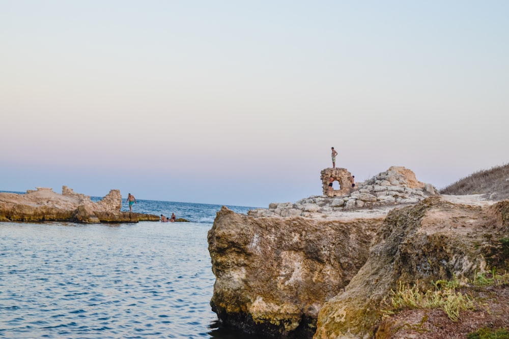 brown rock formation on sea during daytime