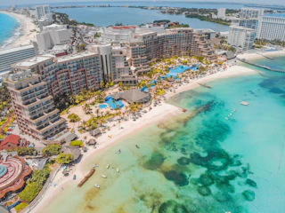 aerial view of city buildings near body of water during daytime