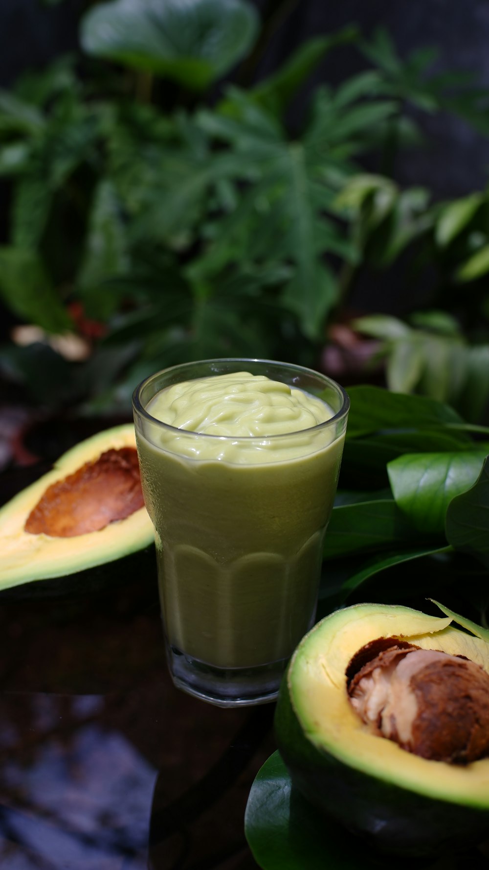 clear drinking glass with green liquid