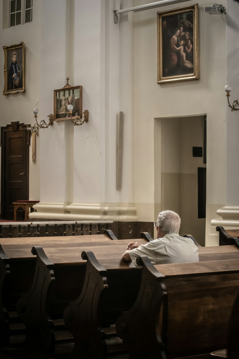 man in white dress shirt sitting on black chair