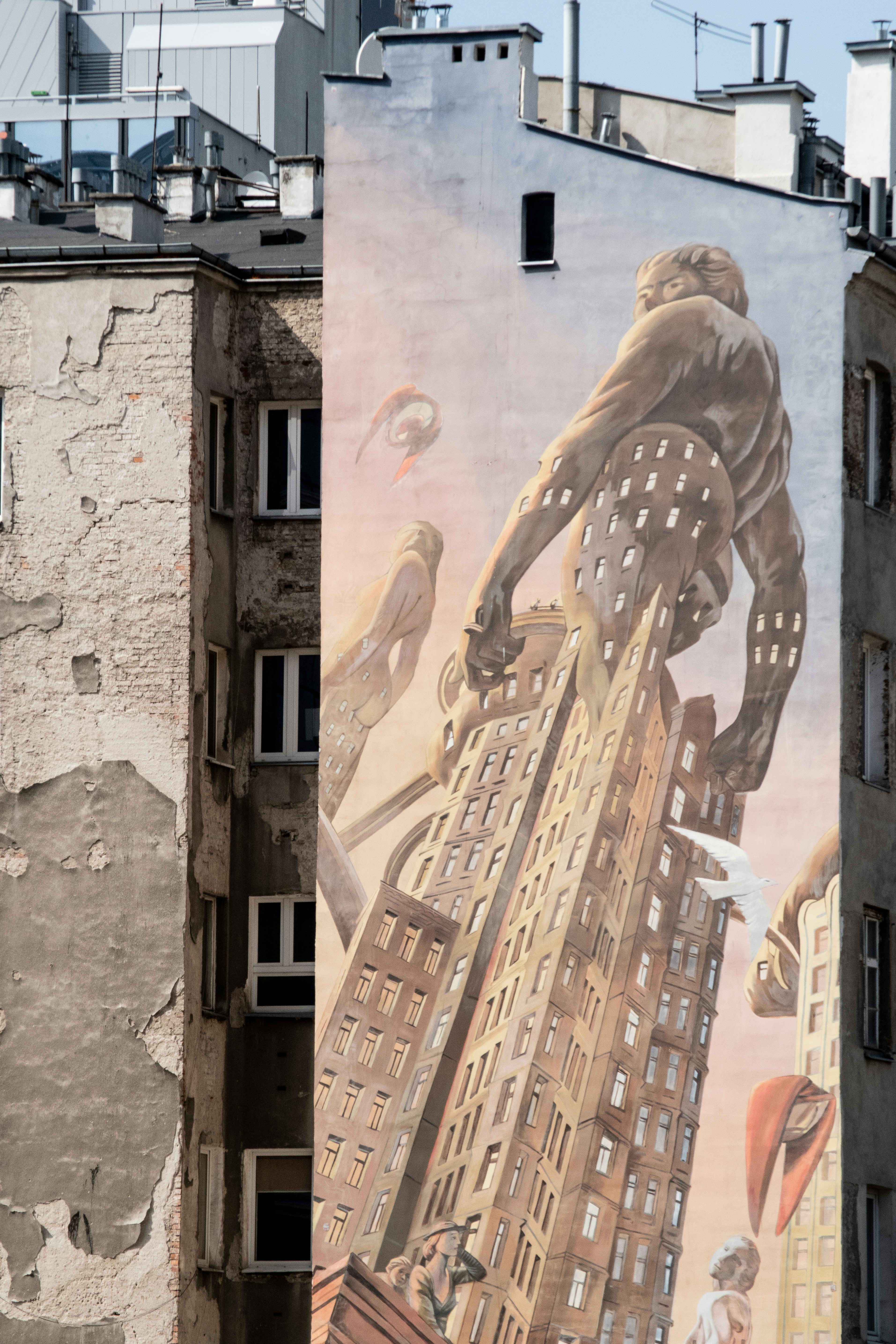 man in black jacket and pants standing in front of building