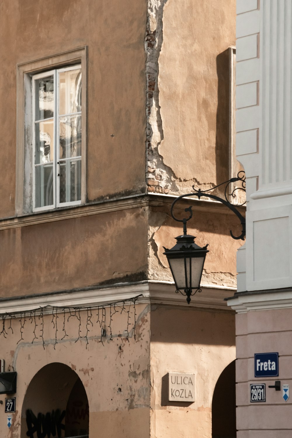 black sconce lamp on brown concrete building