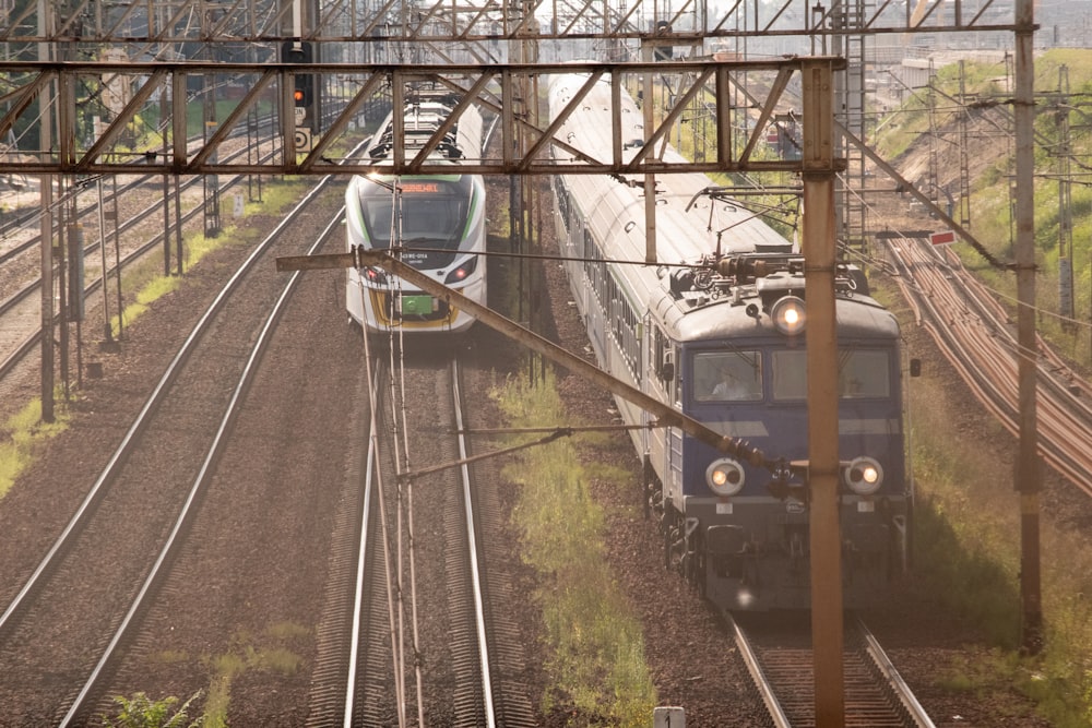 blue and white train on rail tracks during daytime