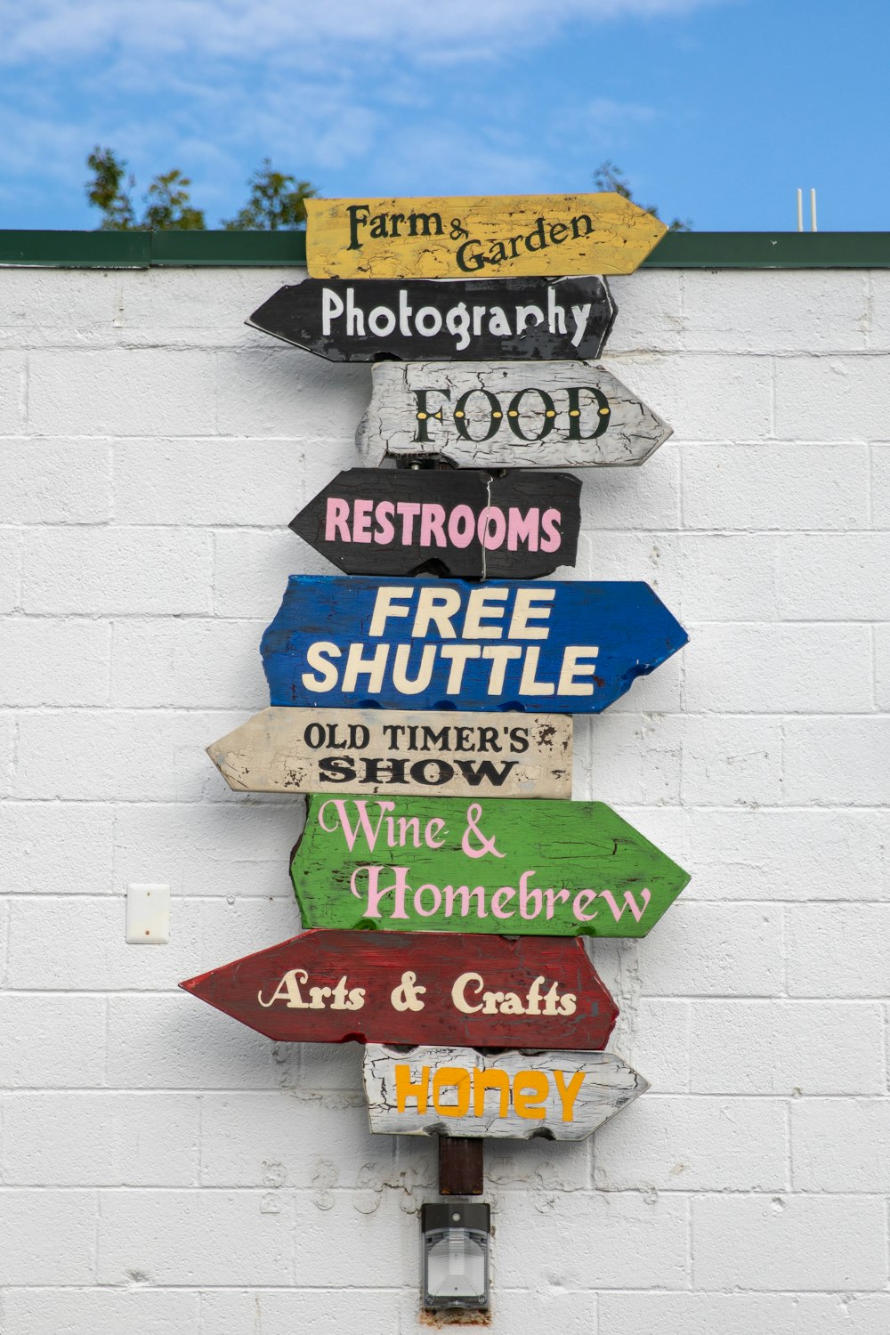 blue and green wooden wall mounted signage