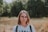 woman in white and black adidas crew neck shirt wearing brown framed eyeglasses