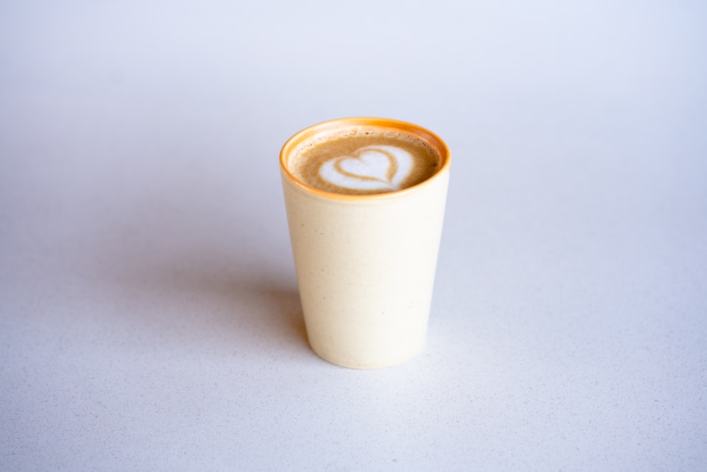 white ceramic cup with brown liquid
