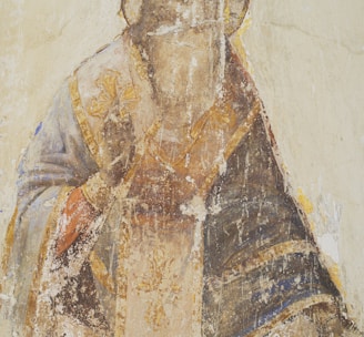 man in brown and black robe painting