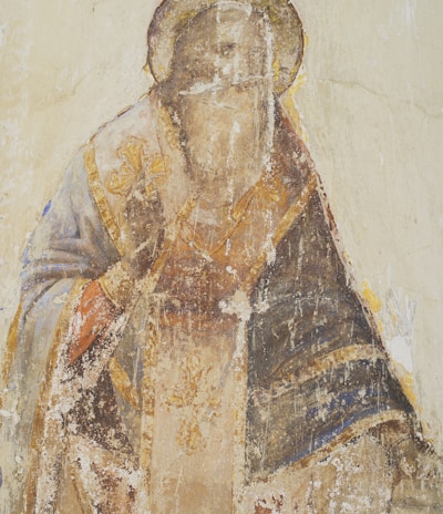 man in brown and black robe painting