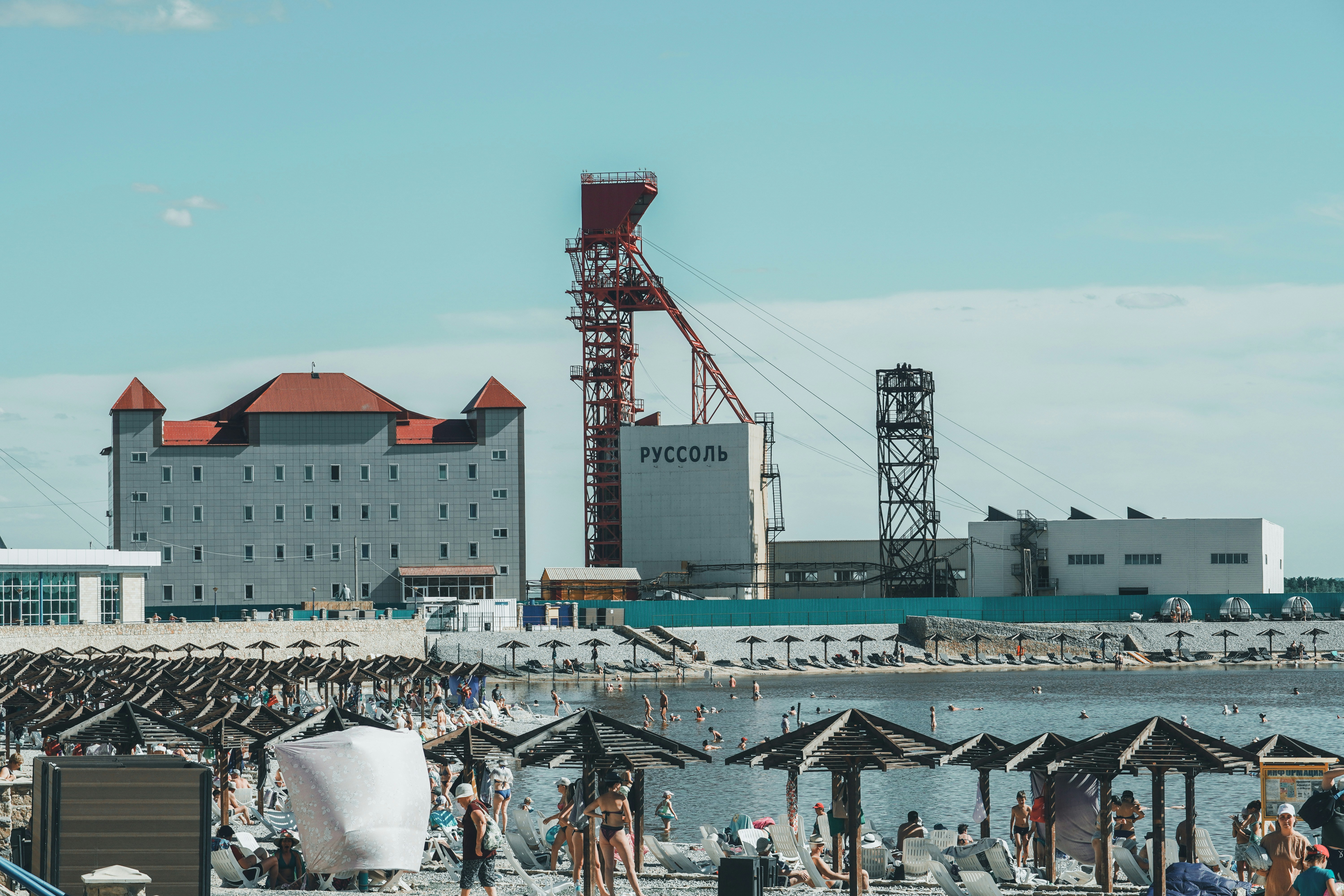 people on beach near buildings during daytime