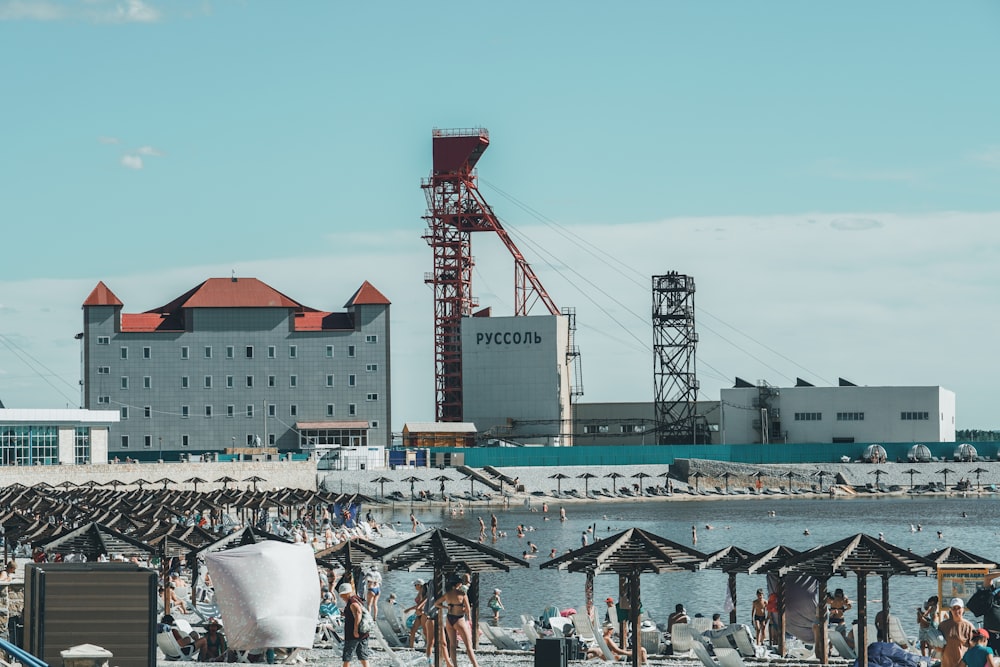 people on beach near buildings during daytime