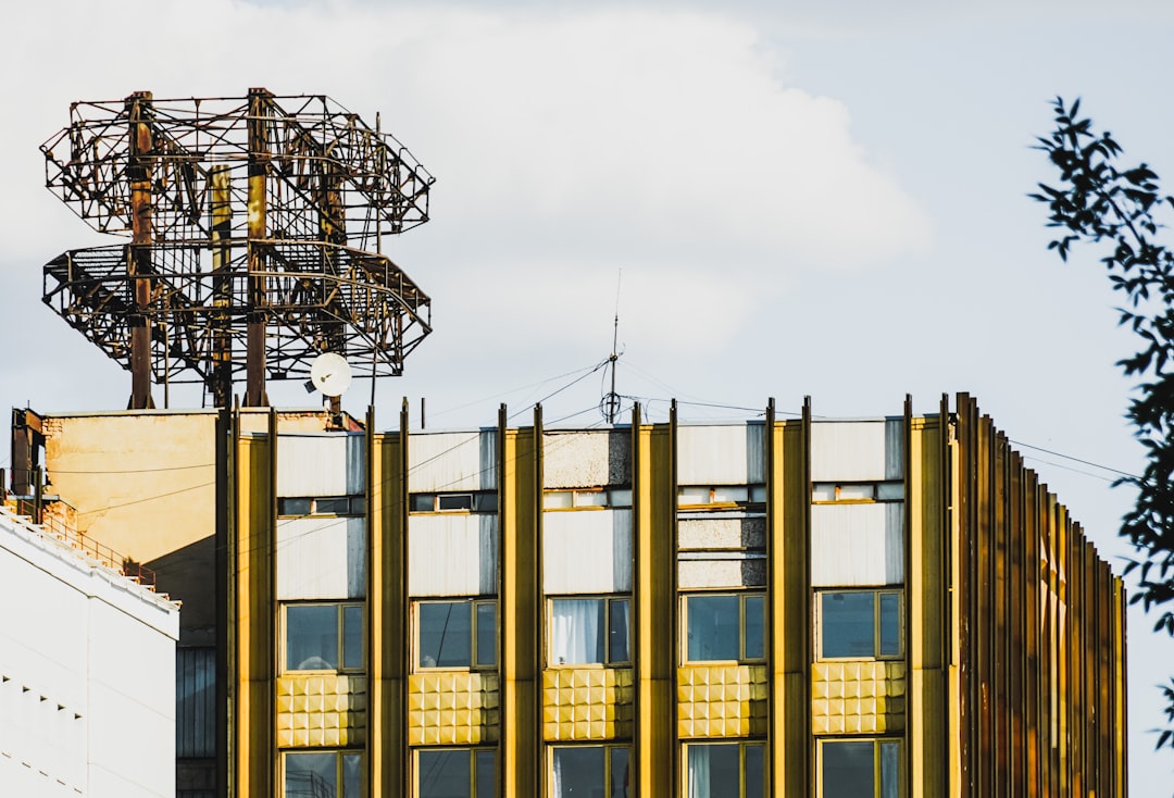 white and brown factory under white sky during daytime