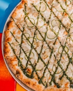 pizza with green leaf on blue plate