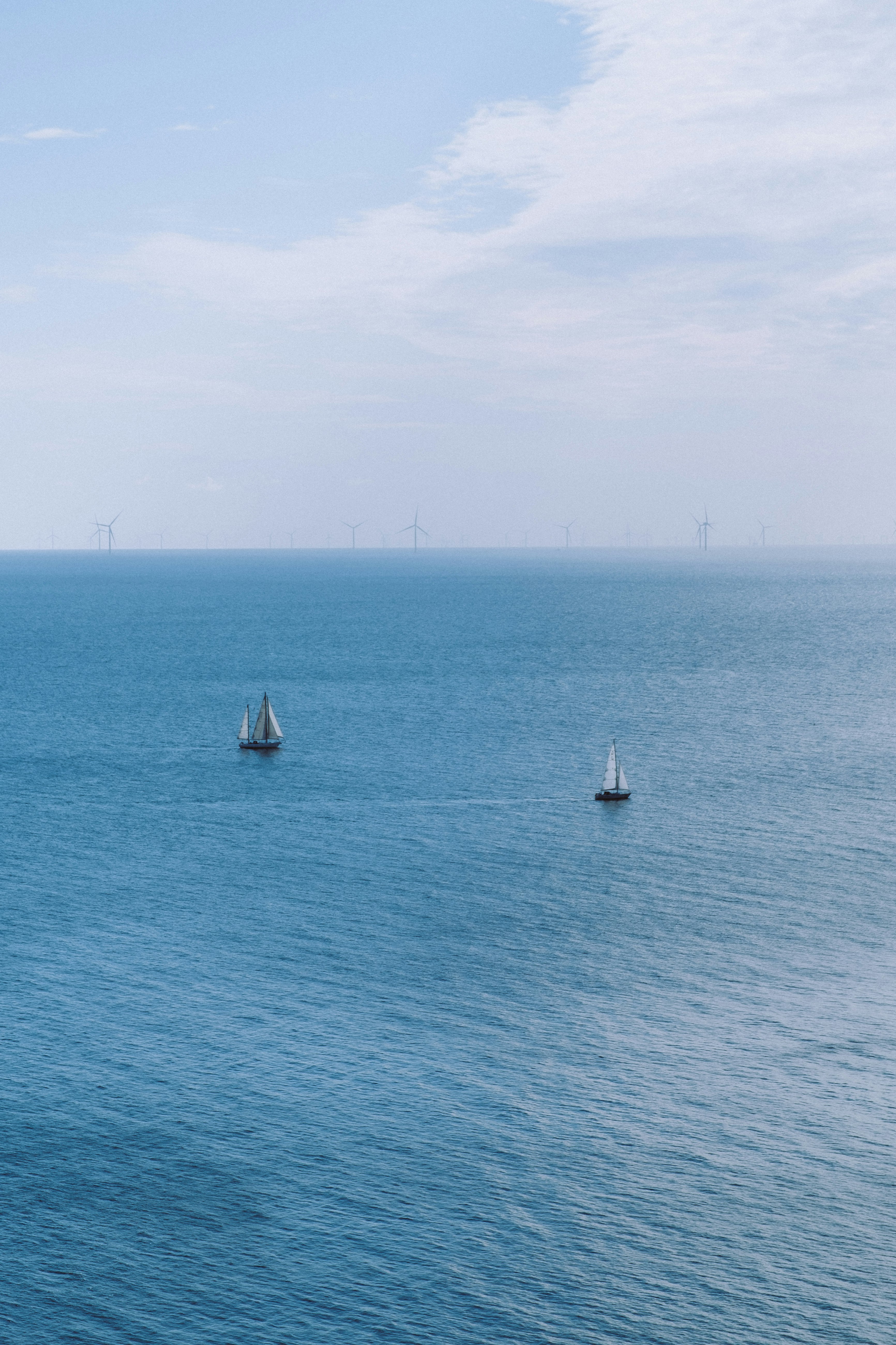 white sail boat on sea during daytime