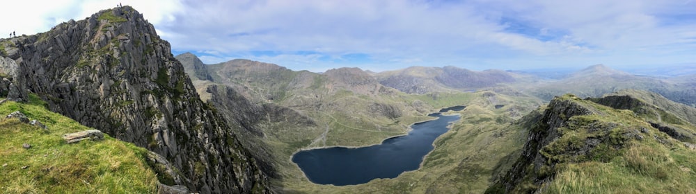 green mountains near body of water during daytime