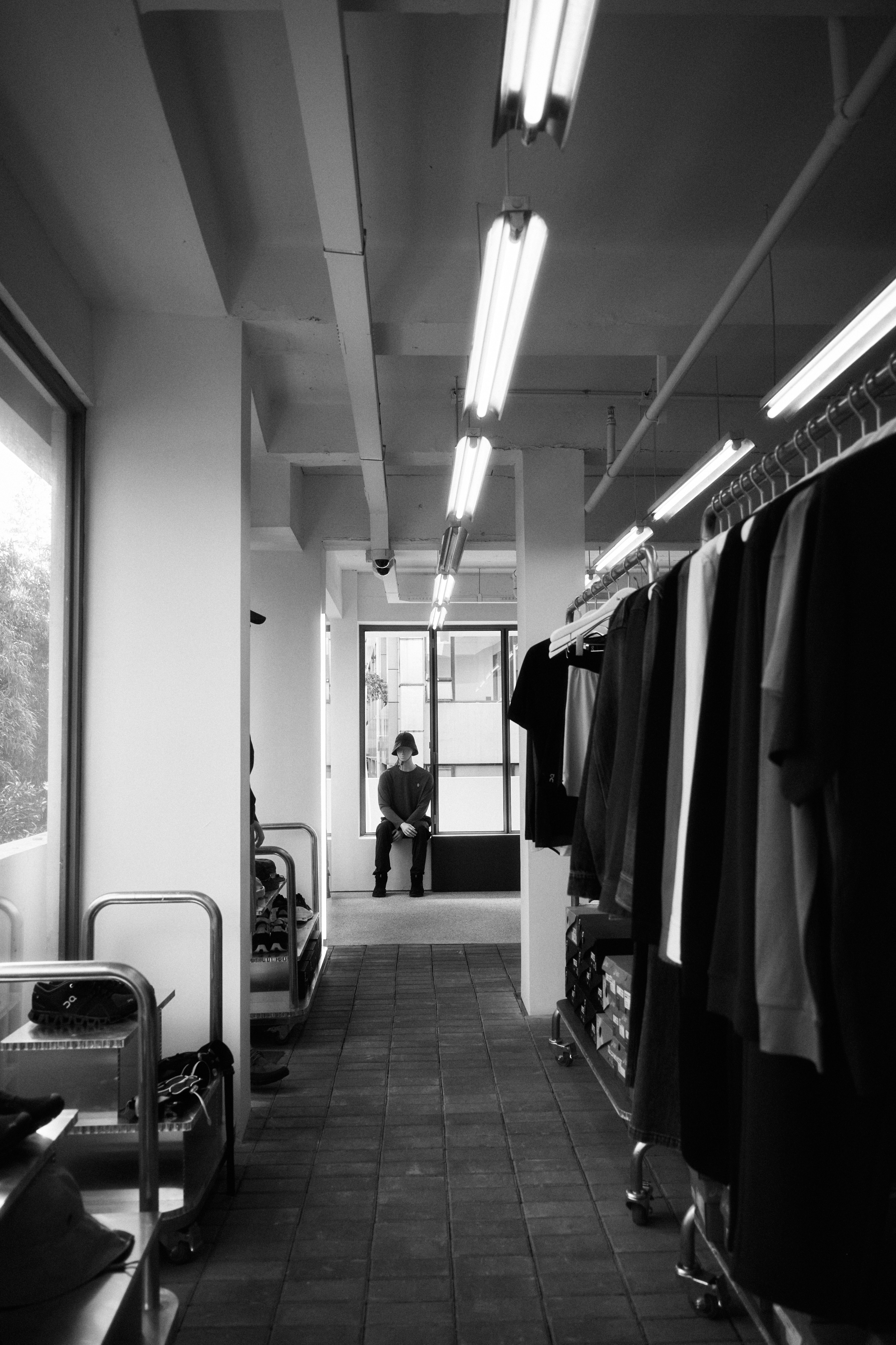 gray-scale-photo-of-clothes-hanging-on-wall-photo-free-image