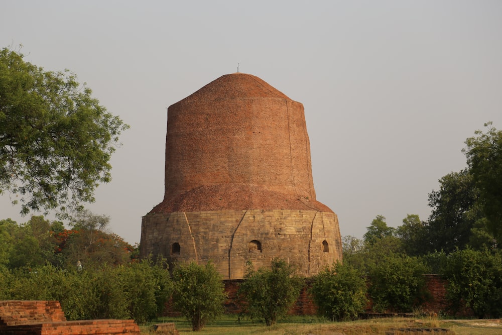 brown concrete building near green trees during daytime