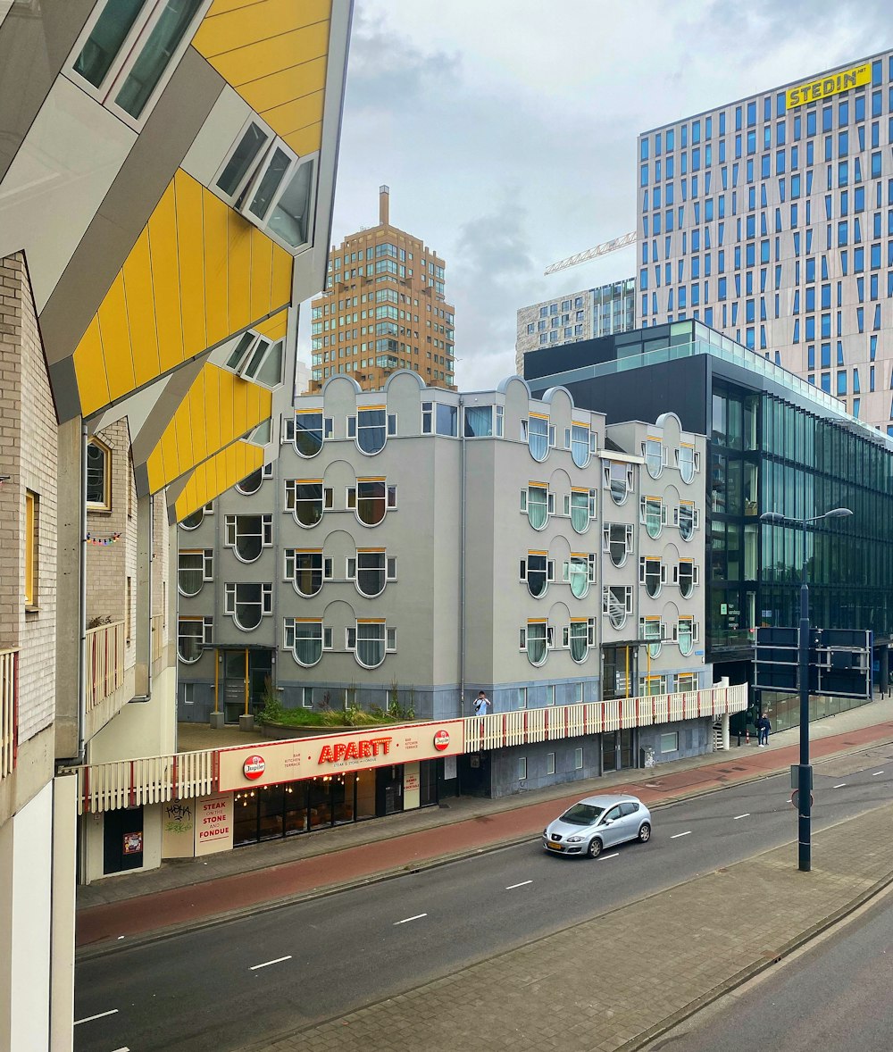 cars parked in front of white concrete building during daytime