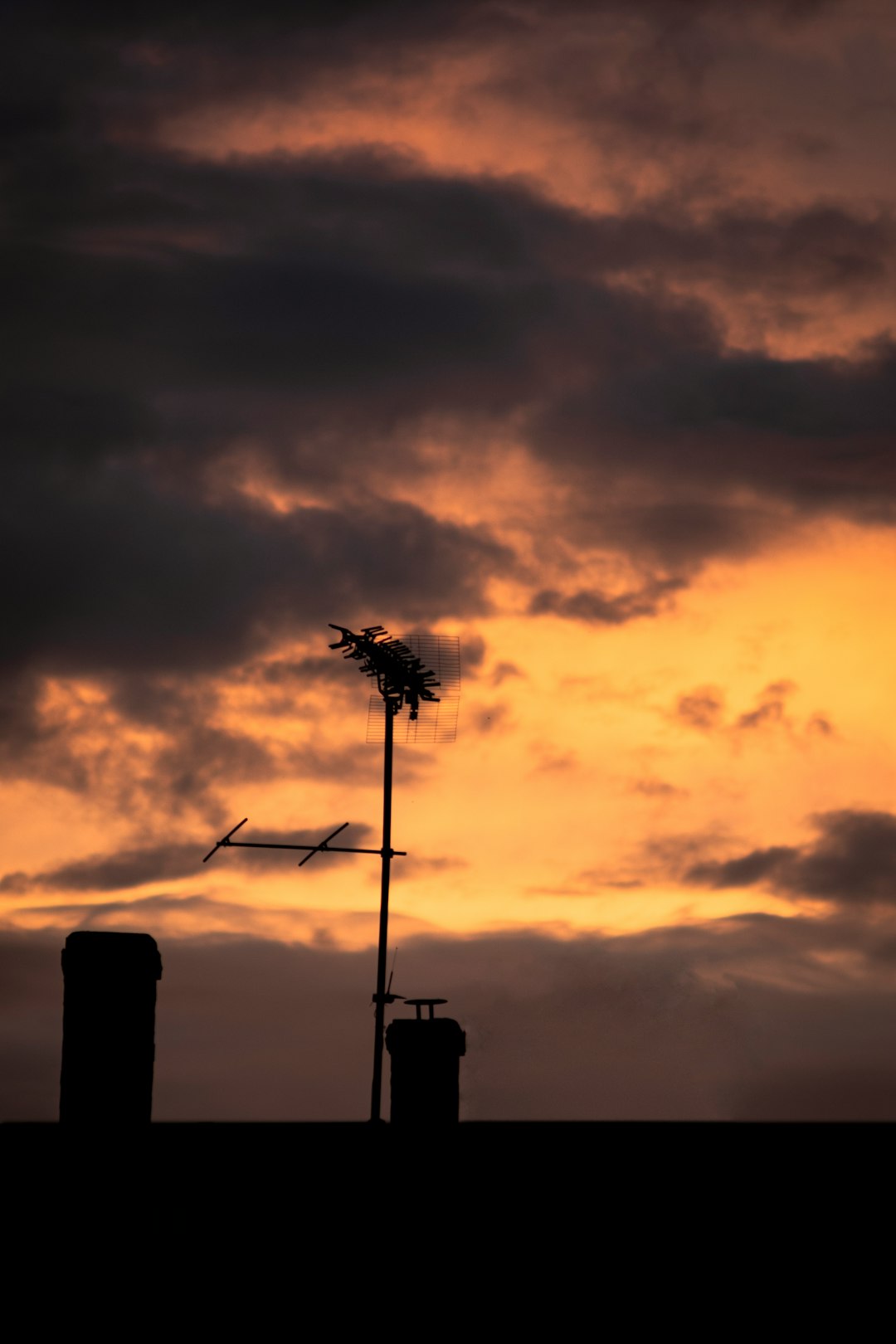 silhouette of wind turbines during sunset
