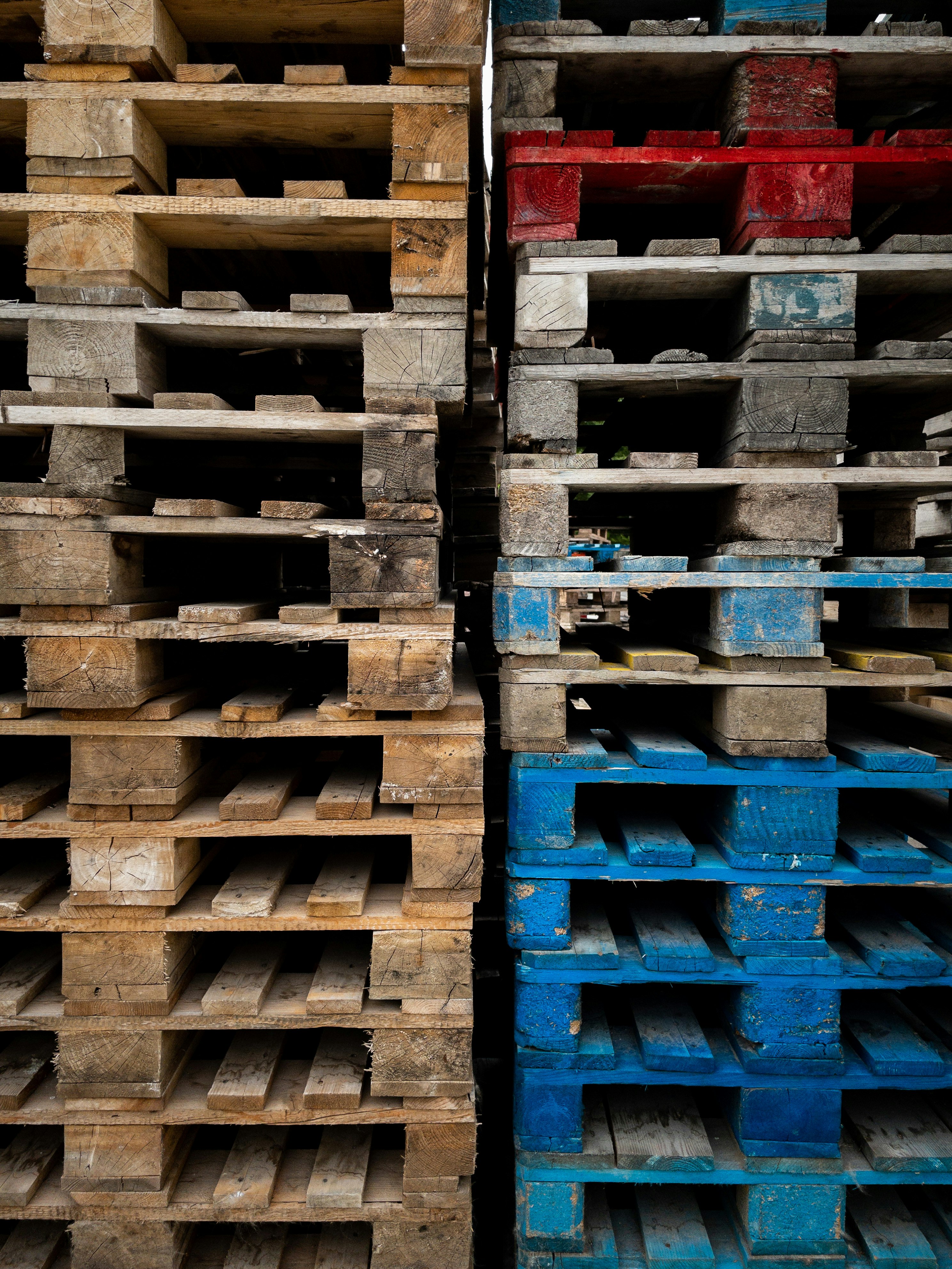brown wooden crates with red and blue plastic crates