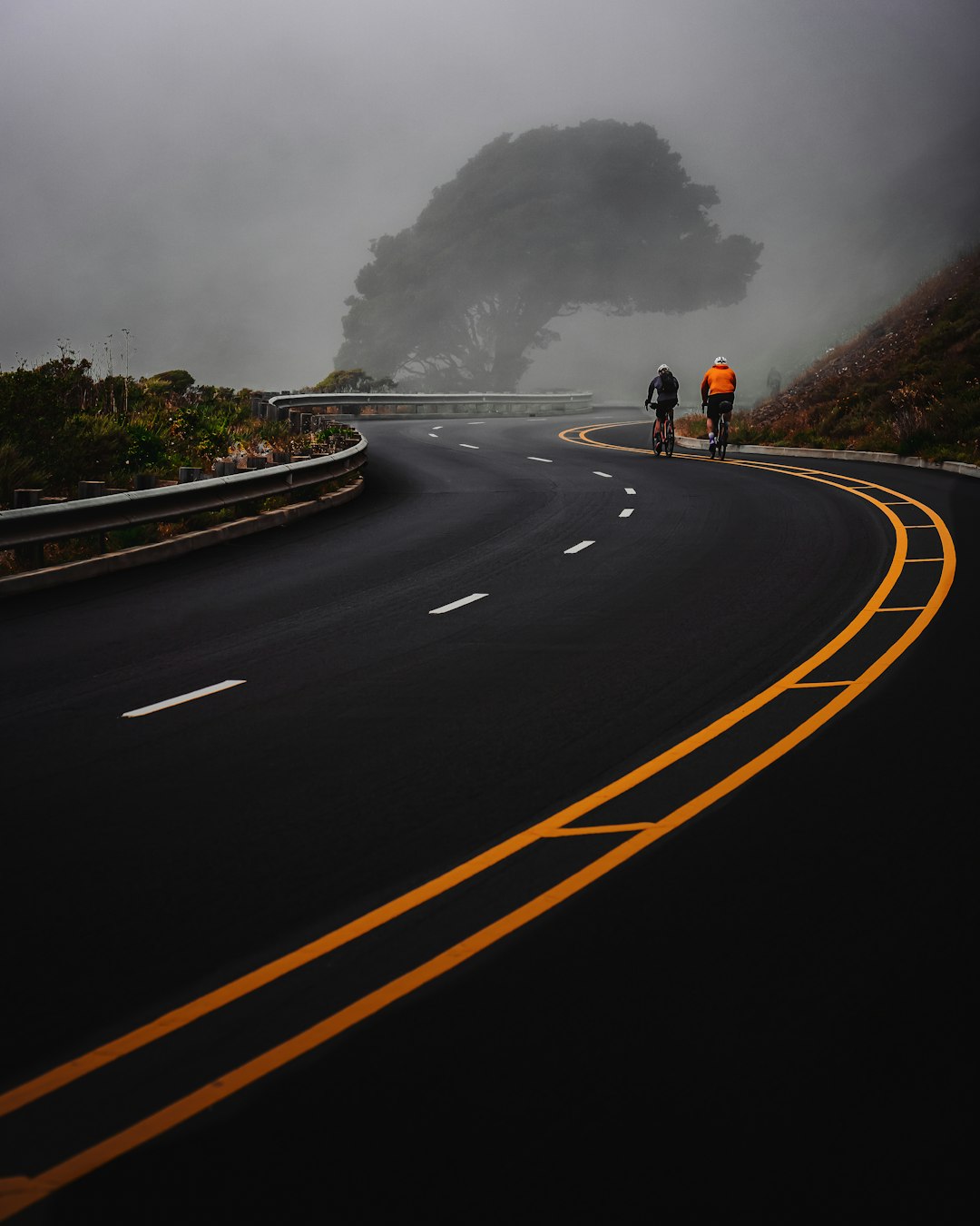 man in black jacket and black pants walking on road during daytime