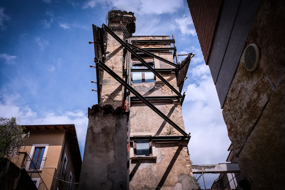 brown metal ladder on brown concrete building during daytime