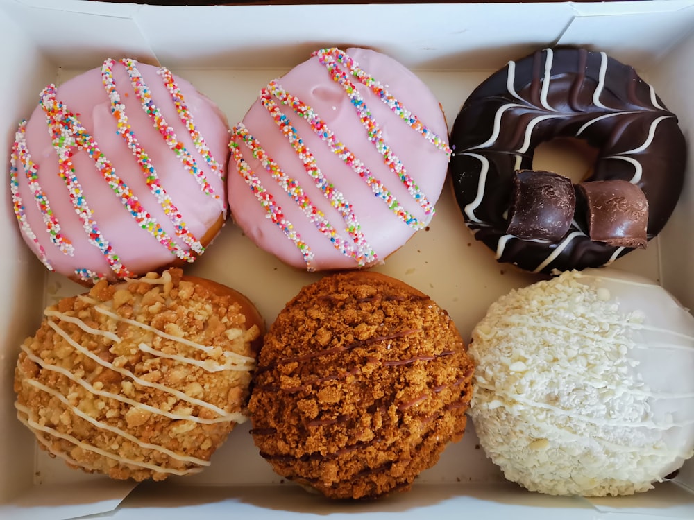 a box filled with different types of donuts