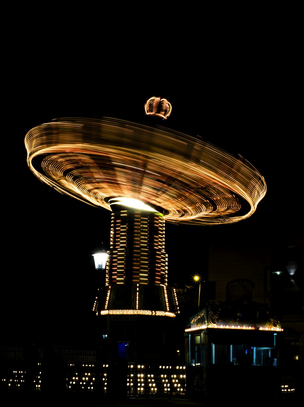 time lapse photography of lights on carousel during night time