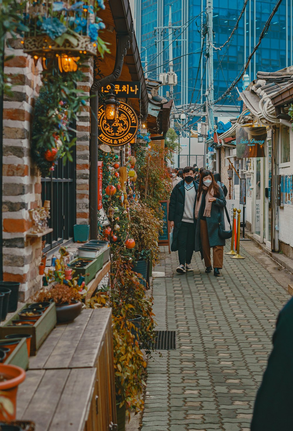 man and woman standing on sidewalk during daytime