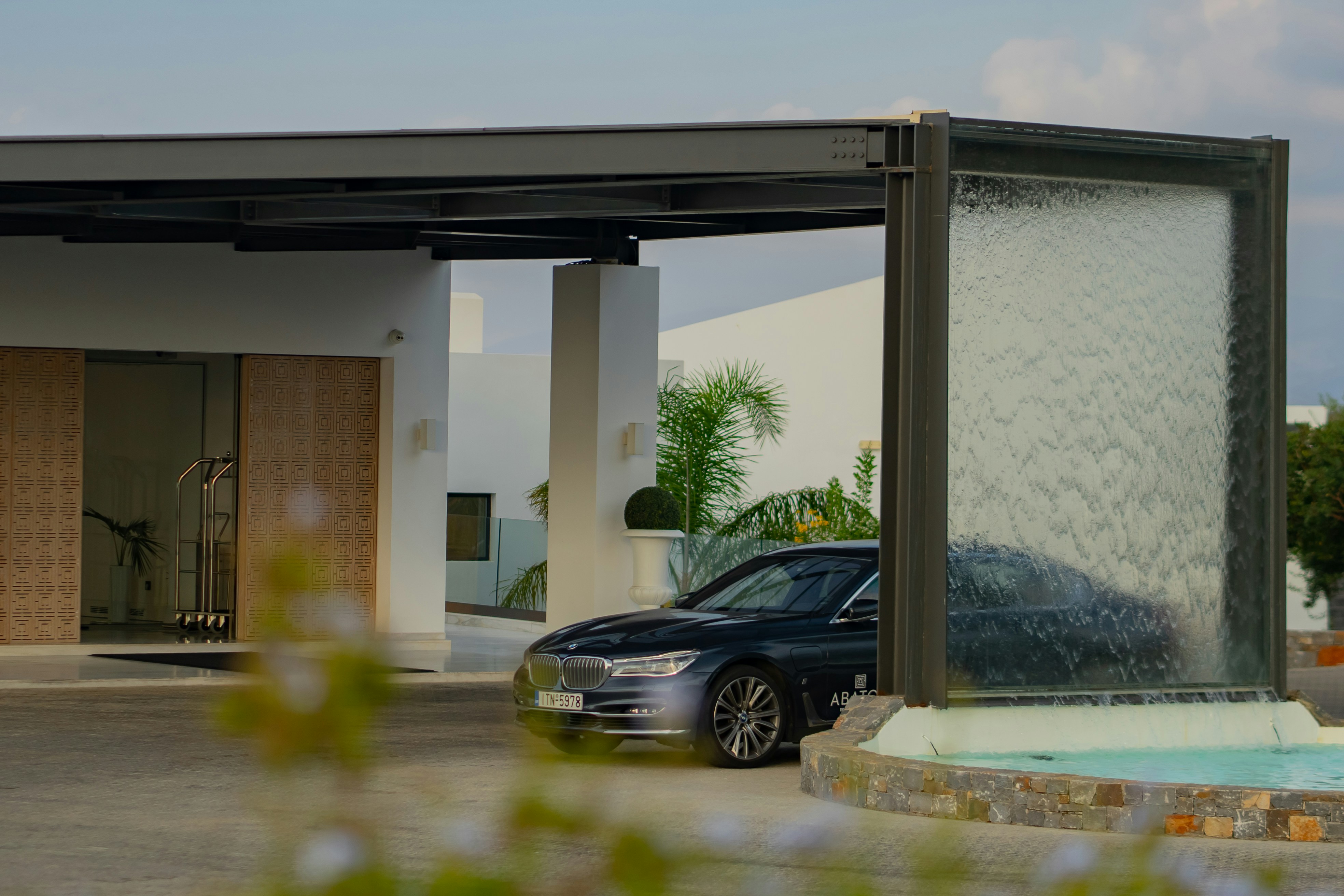 black sedan parked near brown concrete building during daytime, BMW 740L