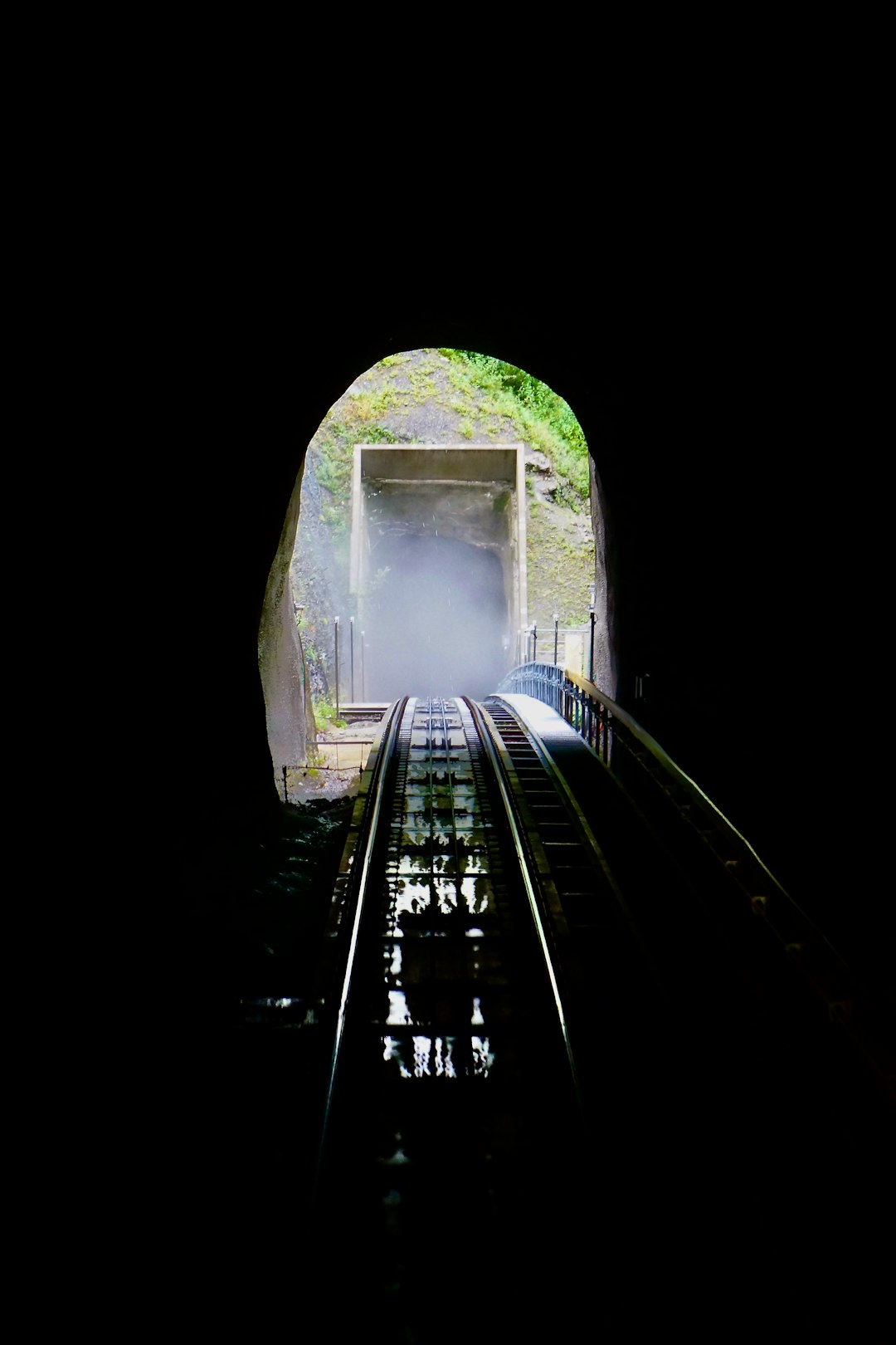 train rail in tunnel during daytime