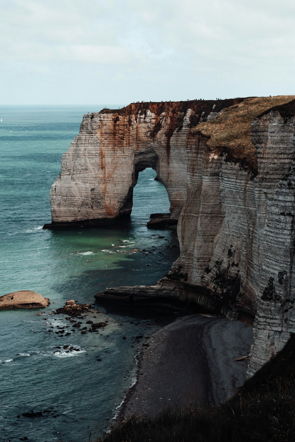 brown rock formation on sea during daytime