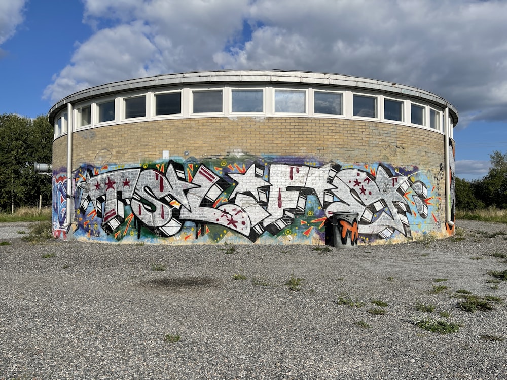 graffiti on wall under cloudy sky during daytime