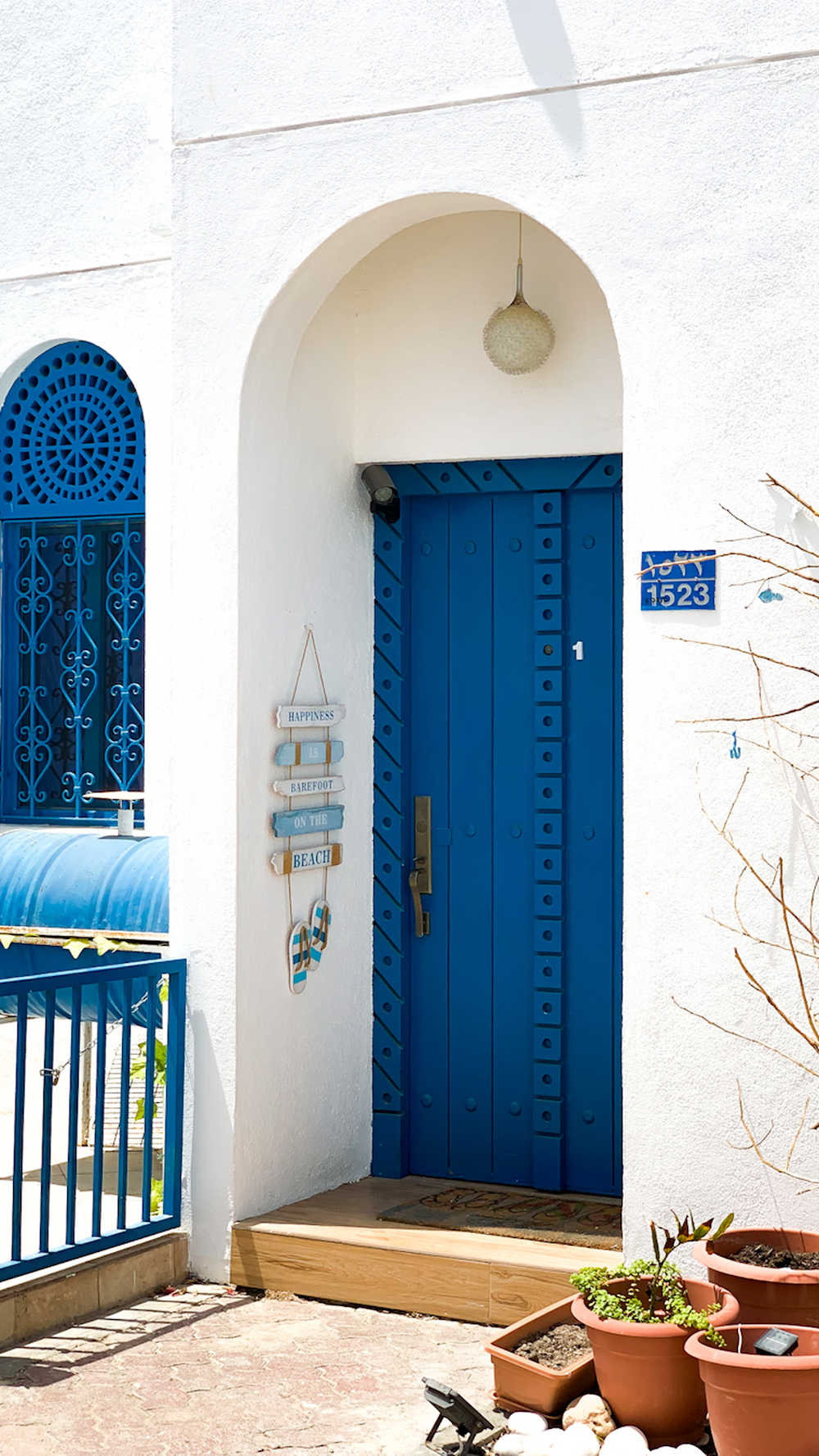 blue wooden door on white concrete building