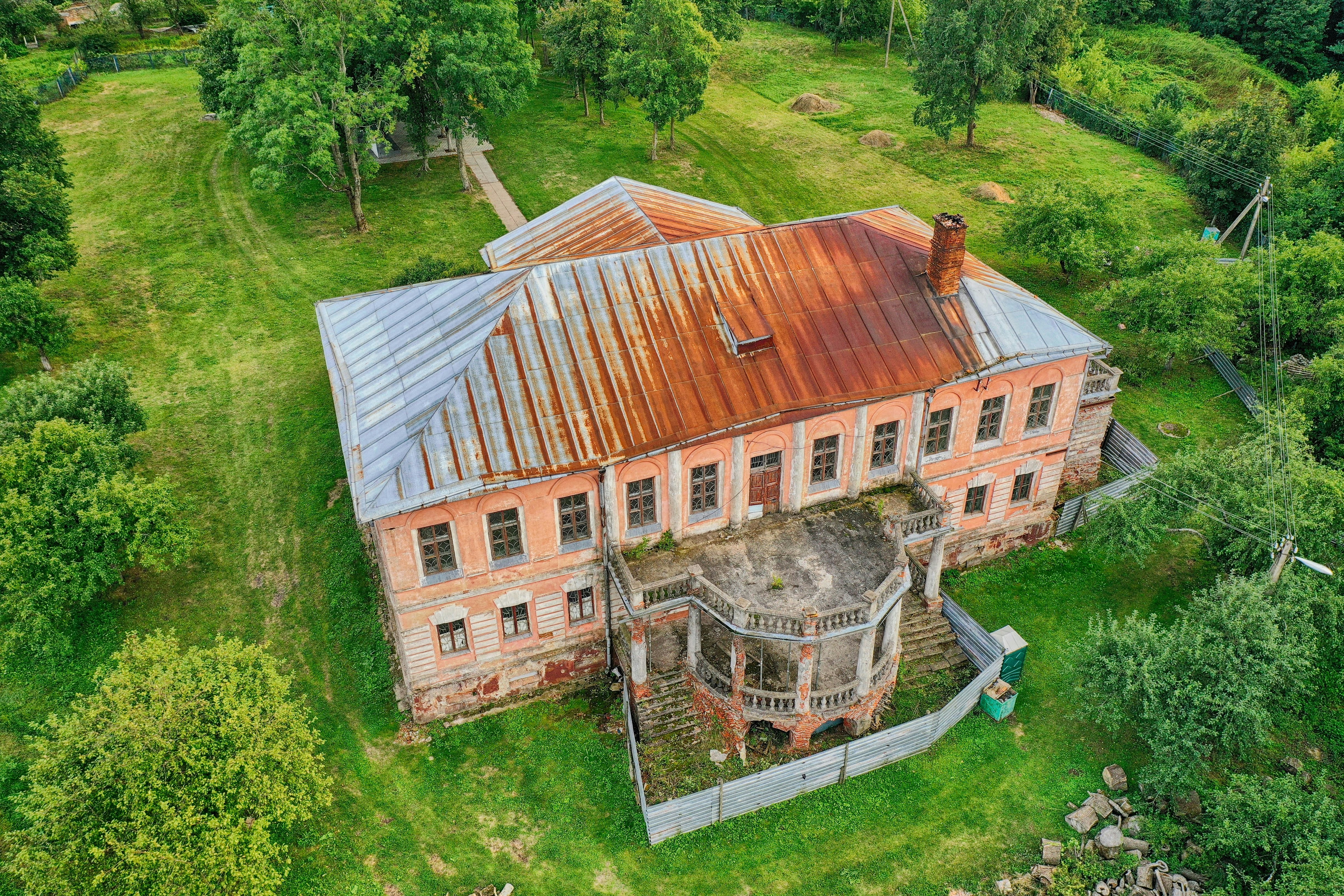 brown wooden house on green grass field during daytime