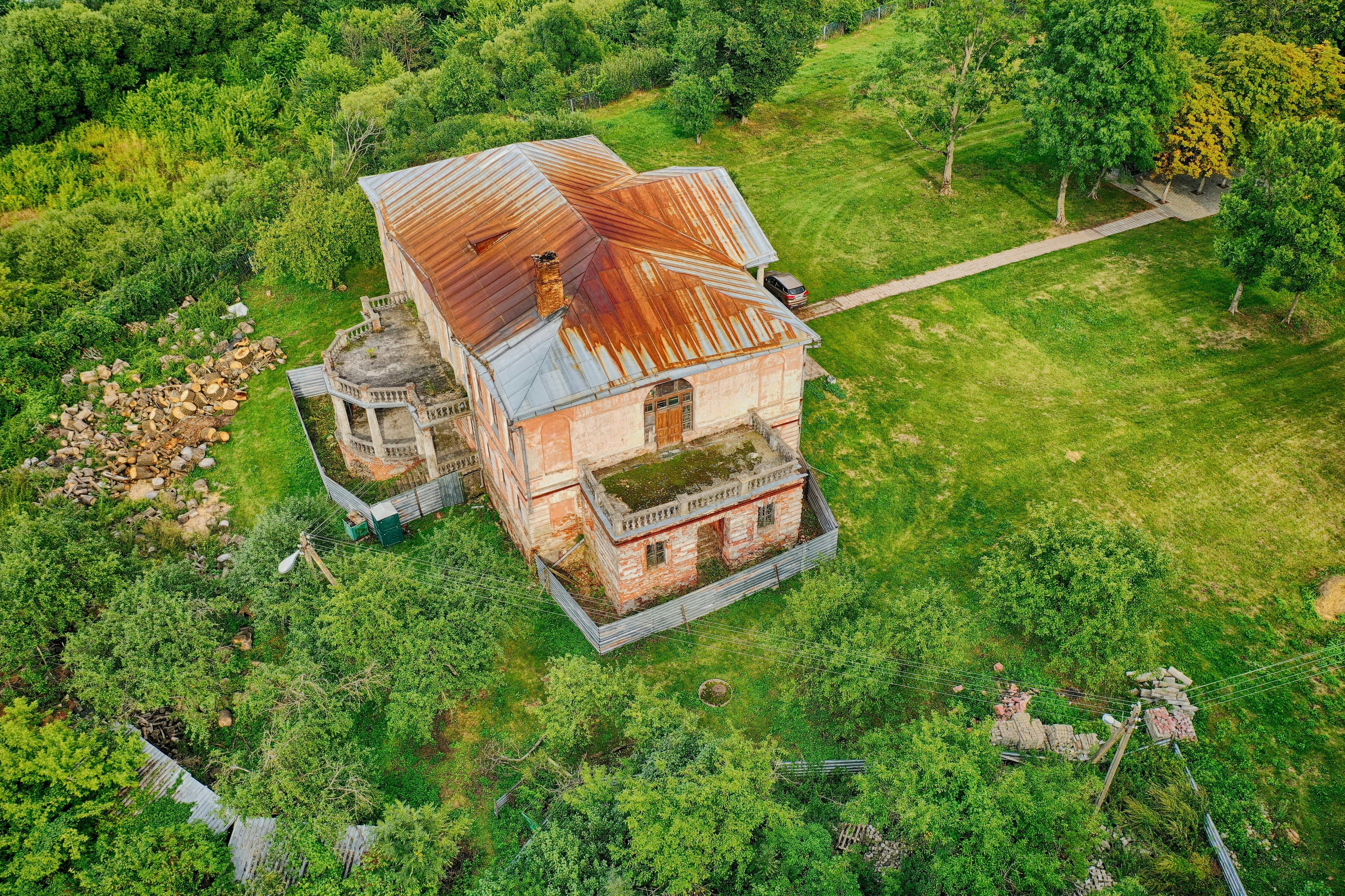 brown wooden house on green grass field during daytime