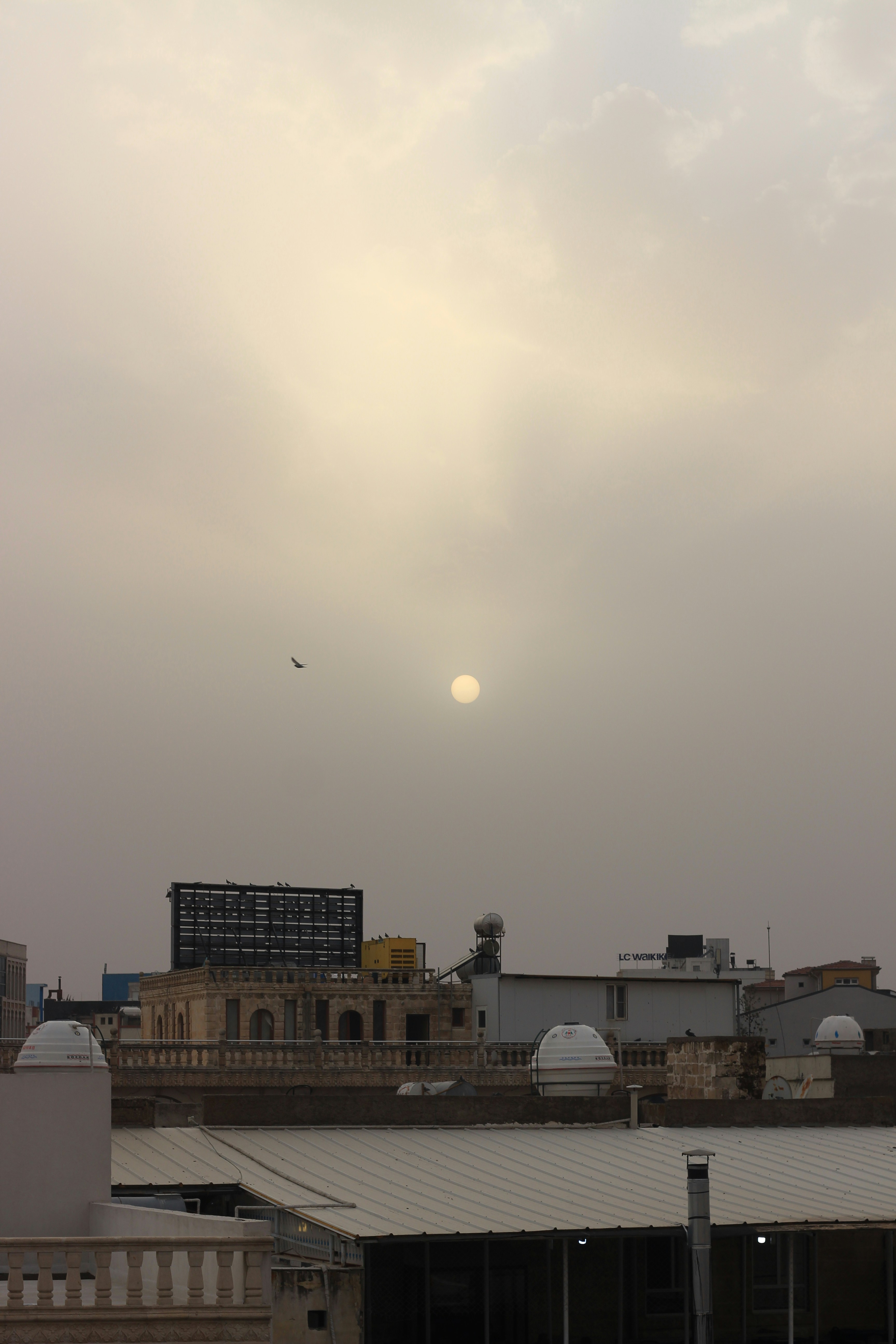 white concrete building under white sky during daytime