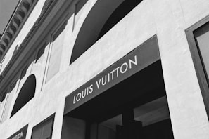 a black and white photo of a louis vuitton store