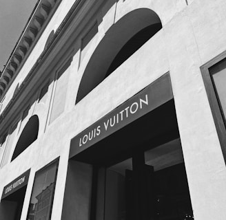 a black and white photo of a louis vuitton store