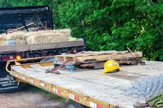 yellow and black heavy equipment on brown wooden pallet