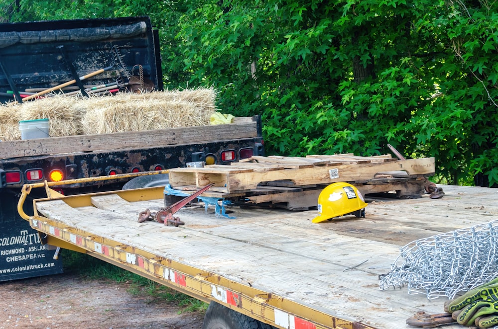 yellow and black heavy equipment on brown wooden pallet