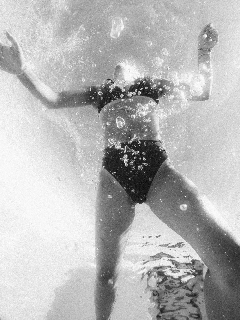 woman in black bikini in water